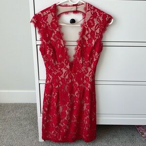 Red, lace cocktail mini dress with a deep v-neck and open back.